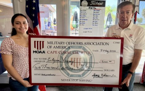 article image - Gary Nolan, President of the Cape Coral Chapter of the Military Officers Association of America JROTC Cadet Elyssa Vazquez $2,000 scholarship